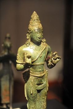 an old statue is on display in a museum