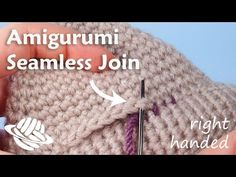 someone crocheting an amigurmi beanie with the needle pointed at it