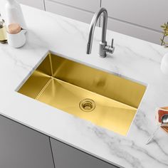 a kitchen sink that is gold in color