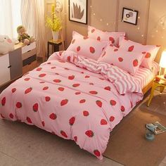 a pink bed with strawberry print on it