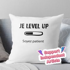 a white pillow with the words je level up and an image of a pen on it