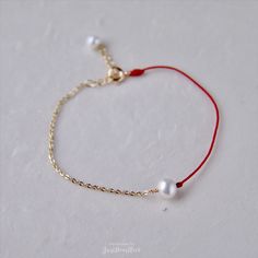 Unique designs of red thread and gold chain bracelets with freshwater pearls. Adjustable Red Jewelry With Pearl Charm, Elegant Red Pearl Bracelets, Red Pearl Bracelets As A Gift, Red Pearl Bracelet As A Gift, Red Pearl Bracelets For Gifts, Red Pearl Bracelets For Gift, Red Pearl Bracelet As Gift, Red Pearl Bracelet Gift, Bracelet Extender