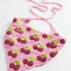 a pink crocheted bag with cherries on it