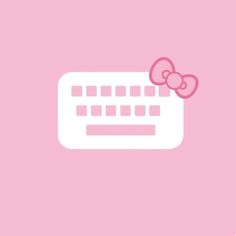 a computer keyboard with a pink bow on it