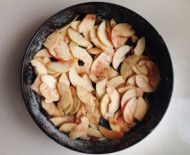 sliced apples in a frying pan on a table