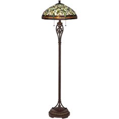 a floor lamp with a stained glass shade on the top and an ornate iron base