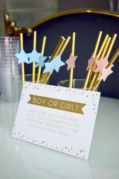 some gold and blue straws in a cup with a sign that says boy or girl?