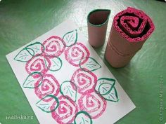 a paper towel and some crochet flowers on a green table with a cup of coffee