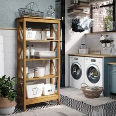 a washer and dryer in a laundry room next to a shelf filled with towels