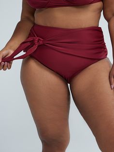 You'll be giving GODDESS in this sexy bikini bottom that stands out in a gorgeous shade of burgundy. With ruching detail and side tie, this stretchy bikini bottom will elevate your swimwear collection like no other. Featuring our innovative and functional four-way stretch fabric that’s ultra-soft yet strong, the quick dry fabric provides SPF/UPF 30+ sun protection, resists chlorine and is wrinkle-free and shrinkage-free. Pair with the matching bikini top (sold separately) or mix and match with other swim separates to create cute looks all season long. | Plus Size Side Tie High Waist Bikini Bottom in True Burgundy Size 4 - Fashion to Figure Cute Looks, Shades Of Burgundy, Fashion Bottoms, Fashion To Figure, Swimwear Bottoms, Black Dresses Casual, Knit Tees, Skirt Leggings, Swimwear Collection