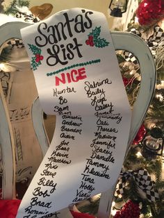 a christmas wish list on a chair in front of a tree