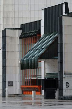 an orange and black building on a rainy day