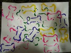 this is an image of a paper with dog bones on it and colored crayons