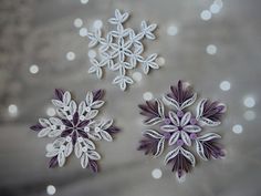 three snowflakes are shown on a table