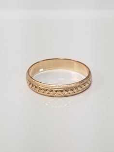 "Thanks for shopping our vintage estate store. We tend to sell well below wholesale and truly hope you enjoy all of our items. Many of the items are one of a kind, so please enjoy scrolling through the pictures and hopefully something will catch your eye. Brown spots are from the camera's reflection. Nice estate 14k yellow gold wedding band edged diamond cut design. Ring size: 6 Width: 4mm 3/16\" Weight: 2.46 grams Marked 14k as all our gold is marked or tested. We do not sell gold plated items. Classic Gold Jewelry For Wedding, Classic Engraved Band As Gift, Classic Round Band Jewelry For Marriage, Classic Round Bands As Gifts, Antique Engraved Ring With Decorative Band For Anniversary, Heirloom Classic Jewelry For Anniversary, Heirloom Jewelry With Classic Design For Anniversary, Formal Vintage Engraved Ring With Decorative Band, Classic Engraved Bands For Anniversary