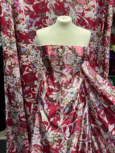 a mannequin wearing a red and white floral dress