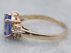 The shoulders of this vintage bypass ring feature twinkling diamonds, which bring a sense of movement to the ring and echo the curves of the sweeping shoulders. We've set this vintage mounting with a bright tanzanite gemstone that flashes in shades of lilac and lavender.Metal: 14K Yellow GoldGem: Tanzanite 1.99 CaratsGem Measurements: 9.3 x 6.8 mm, OvalAccents: 10 Diamonds totaling .25 Carats, SI in Clarity, G in ColorRing Size: 8.50Marks: “B&F 14KT” Stamped on the inside band