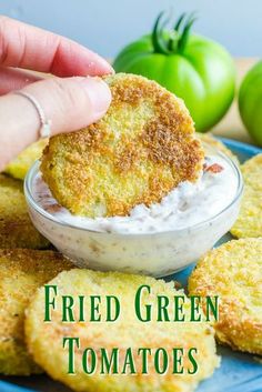 fried green tomatoes with ranch dip in a small bowl on a blue plate next to some crackers