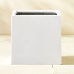 a white box sitting on top of a tiled floor