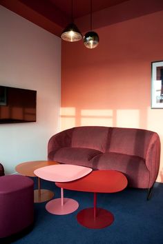 a living room with pink and purple furniture