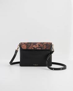 Our Deco Blooms Crossbody is the ultimate blend of functionality and style. With multiple compartments to keep your belongings safe, and a flap printed with the enchanting Deco Blooms design, this purse is made for carefree days spent wandering through art galleries or exploring hidden city gardens.

Key features:


Outer: 100% Polyurethane; Lining: 100% Polyester



Approx. 9.25" (L) x 6.3" (H) x 1.2" (D) cm



Wipe clean with a damp cloth Black Rectangular Travel Flap Bag, Black Rectangular Flap Bag For Travel, Travel Flap Bag With Removable Pouch, Fable England, Hidden City, City Gardens, Luxury Christmas Gifts, Retro Bags, Black Crossbody Purse