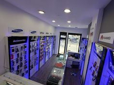 the inside of an electronics store with blue lights