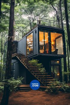 a house made out of shipping containers in the woods with stairs leading up to it