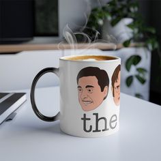 a coffee mug with the faces of two men on it and steam rising from its top