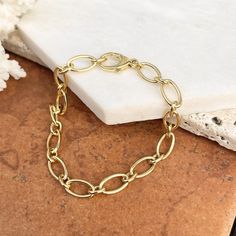 Polished 14KT yellow gold oval, open, links design chain bracelet. This gold chain bracelet looks fantastic from all angles! An ideal starter charm bracelet. Length: 7.5" 14K round trigger lobster clasp Width: 9.5mm at wides link Weight: 13.86g Stamped 14K Made in Italy Luxury Oval Gold Chain Bracelet, Luxury Oval Link Chain Bracelets, Saint Jewelry, Gold Chain Bracelet, Link Design, Design Bracelet, Gold Bracelet Chain, Yellow Gold Bracelet, Gold Polish