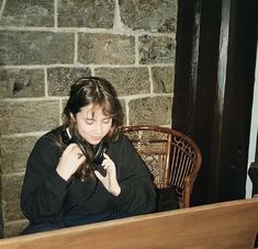 a woman sitting in front of a piano