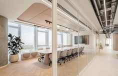 an empty conference room with large windows overlooking the city