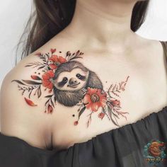 a woman's chest with flowers and a slotty in the center on her chest