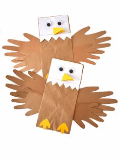 two paper bag puppets made to look like an eagle