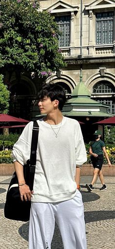 a young man standing in front of a building