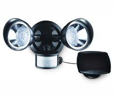 an outdoor security light with two lights on it's sides and a charger