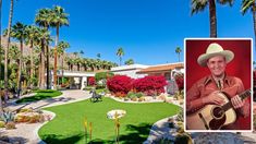 a man in a cowboy hat holding a guitar next to a fake lawn and palm trees