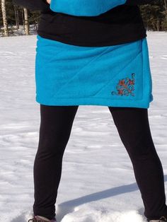 "The Quilted Bum Daisy will keep you warm while being active outside.  Whether you are hiking, walking, jogging, cross country skiing, or dog mushing, this is the skirt for you!  Your biggest muscles will stay warm and keep you going!  This skirt features water resistant double layered anti-pill polar fleece, quilted detail, hits above the knee, large slit on the side for easy movement, elastic waist, and an embroidery design!  It is meant to wear over your normal clothing for those extra chilly days.   You could also wear it over your favorite tights or leggings with winter boots, your healed knee highs, or a chunky pair of buckle boots!  This is a nice alternative to snow pants or long parkas in cold climates.  You can stay warm and look good doing it in style!   Note: If you have any qu Dog Mushing, Insulated Skirt, Warm Skirts, Fleece Skirt, Being Active, Quilted Skirt, Sewing Fleece, Normal Clothes, Long Parka