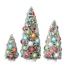 three small christmas trees with ornaments on them