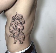 a man's stomach with an origami elephant tattoo on it