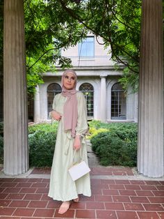 A girl in a green dress in a very nice architecture background Business Idea, Hijabi Fashion, Hijab Outfit