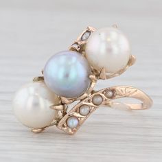 Gemstone Information: - Cultured Pearls - Size - 7 - 7.2 mm  Cut - Round Bead Shape Color - White & Gray - Natural Split Pearls - Size - 1.25 - 1.75 mm  Cut - Half Round Color - White Metal: 14k Yellow Gold Weight: 4.4 Grams  Stamps: 14k Face Height: 17 mm  Rise Above Finger: 10 mm Band / Shank Width: 1.1 mm This ring is a size 5, but it can be resized down 1 size for a $20 fee or up 3 sizes for a $25 fee. If you would like your ring resized, please select the appropriate fee from the listing be Antique Multi-stone Cluster Jewelry, Antique Three Stone Jewelry For Formal Occasions, Antique Three Stone Round Jewelry, Antique 14k Gold Cluster Jewelry, Classic Multi-stone Pearl Ring For Formal Occasions, Heirloom Jewelry With High Luster For Anniversary, Victorian Three Stone Round Jewelry, Antique Round Jewelry With High Luster, Antique Round High Luster Jewelry