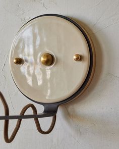 a wall light that is attached to the side of a wall with two lights on it