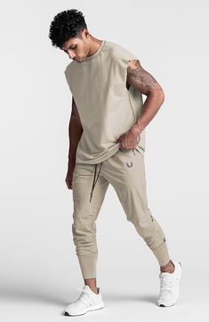 Lightweight, stretchy and ready to conquer the elements, these water-repellent joggers sport a higher waist and tall, stay-put ribbing circling the ankles. They come with secure pockets for holding your keys, cash, phone and energy gels as you run or work out. 28" inseam; 8" leg opening; 12 1/4" front rise; 16 1/2" back rise (size Medium) TETRA-LITE fabric offers lots of stretch plus durable water-repellent (DWR) protection against the elements. 76% nylon, 24% spandex Machine wash, line dry Imported Men Fashion Simple, Men Skater Fashion, Male Pose Reference Action, Gym Style Mens, Mens Athleisure Outfits, Athletic Street Style, Mens Workout Outfits, Mens Athleisure, Men's Athleisure