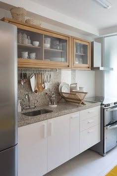 a kitchen with stainless steel appliances and wooden cabinets