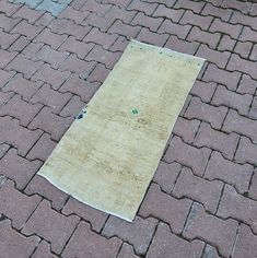 a piece of cloth laying on top of a brick road next to a fire hydrant