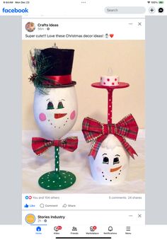 two snowmen with hats and bows on their heads are sitting next to each other