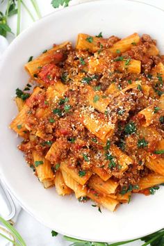 a white bowl filled with pasta and sauce