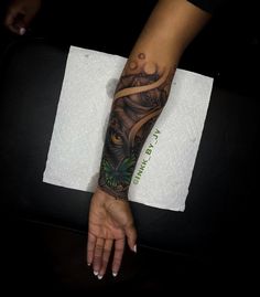 a woman's arm with a tattoo on it and an owl in the middle