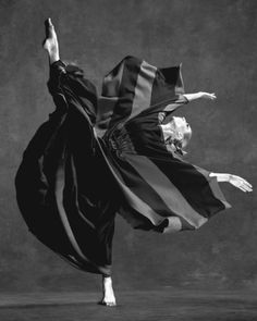 a black and white photo of a woman dancing