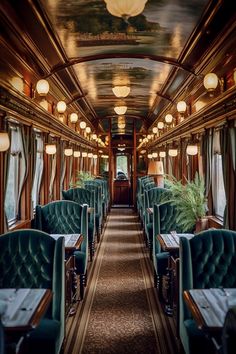 the interior of a train car with green velvet seats and tables on each side, along with lamps hanging from the ceiling